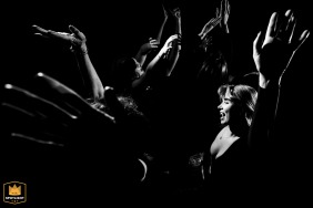 Black and white action shot of the wild dance floor at the Banff Gondola reception. Hands in the air, guests having a great time.